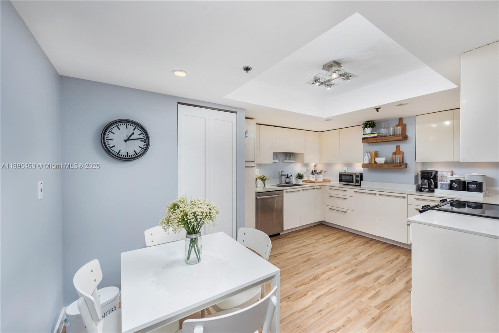 650 Ocean Drive, Unit 10E Key Biscayne, FL 33149 - Photo 11 of 20 a kitchen with a refrigerator and white cabinets
