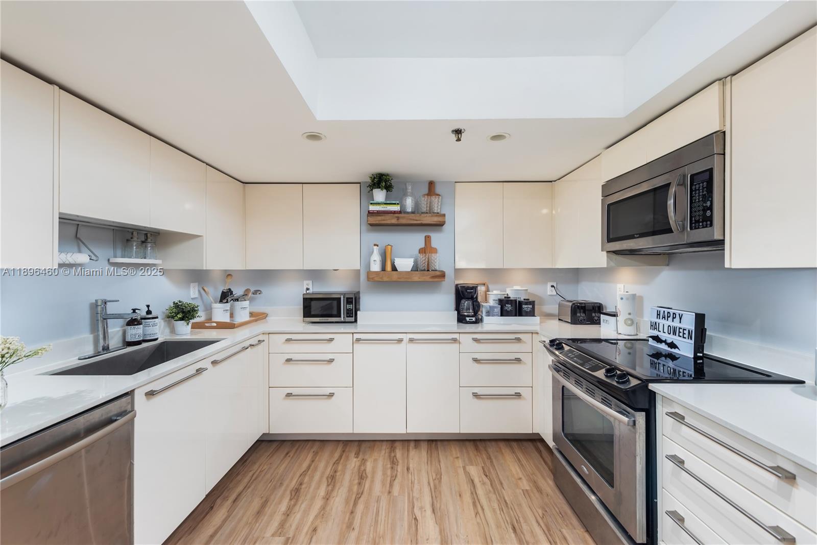 650 Ocean Drive, Unit 10E Key Biscayne, FL 33149 - Photo 12 of 20 a kitchen with cabinets stainless steel appliances a sink and a counter top space