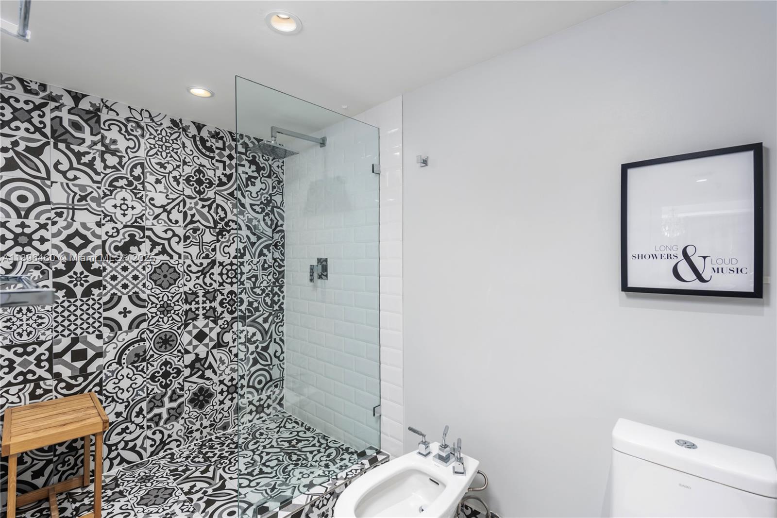 650 Ocean Drive, Unit 10E Key Biscayne, FL 33149 - Photo 18 of 20 a bathroom with a toilet and a shower curtain