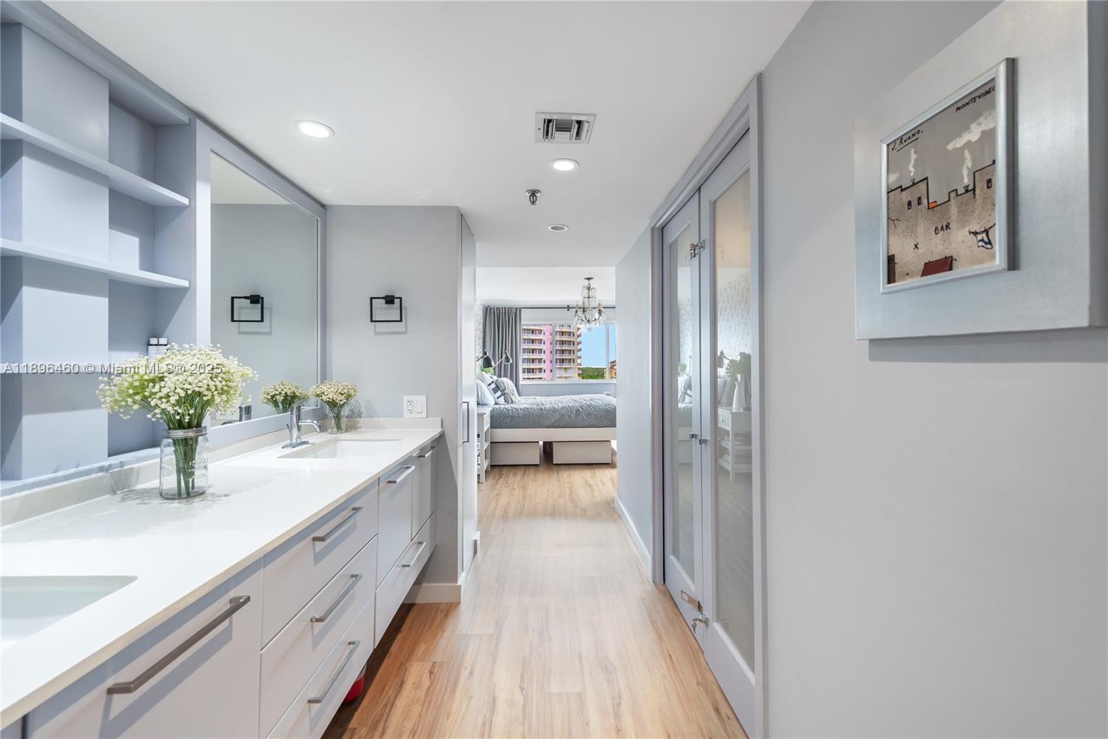 650 Ocean Drive, Unit 10E Key Biscayne, FL 33149 - Photo 19 of 20 a bathroom with a granite countertop sink a large mirror and a shower