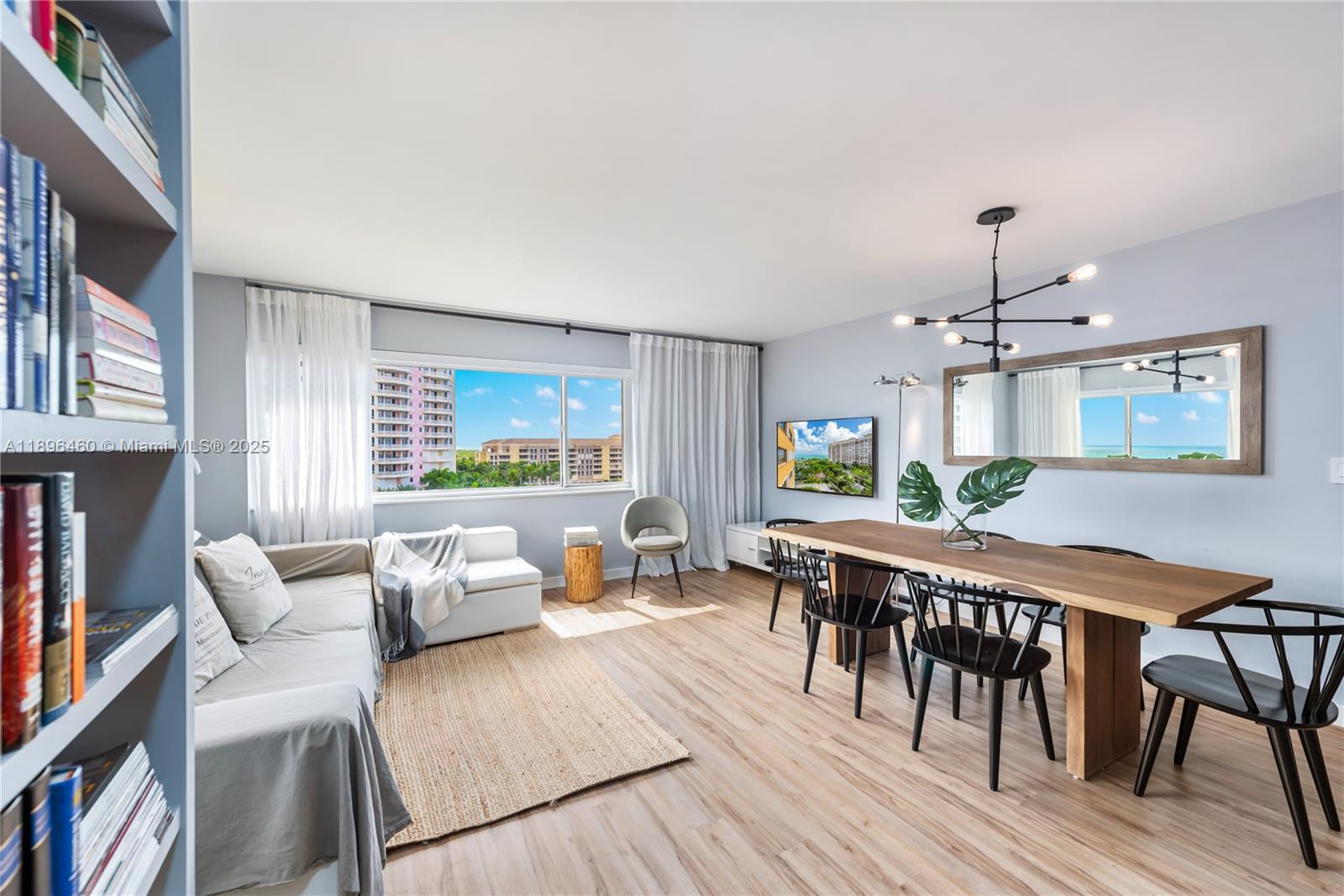 650 Ocean Drive, Unit 10E Key Biscayne, FL 33149 - Photo 2 of 20 a living room with furniture two window and wooden floor