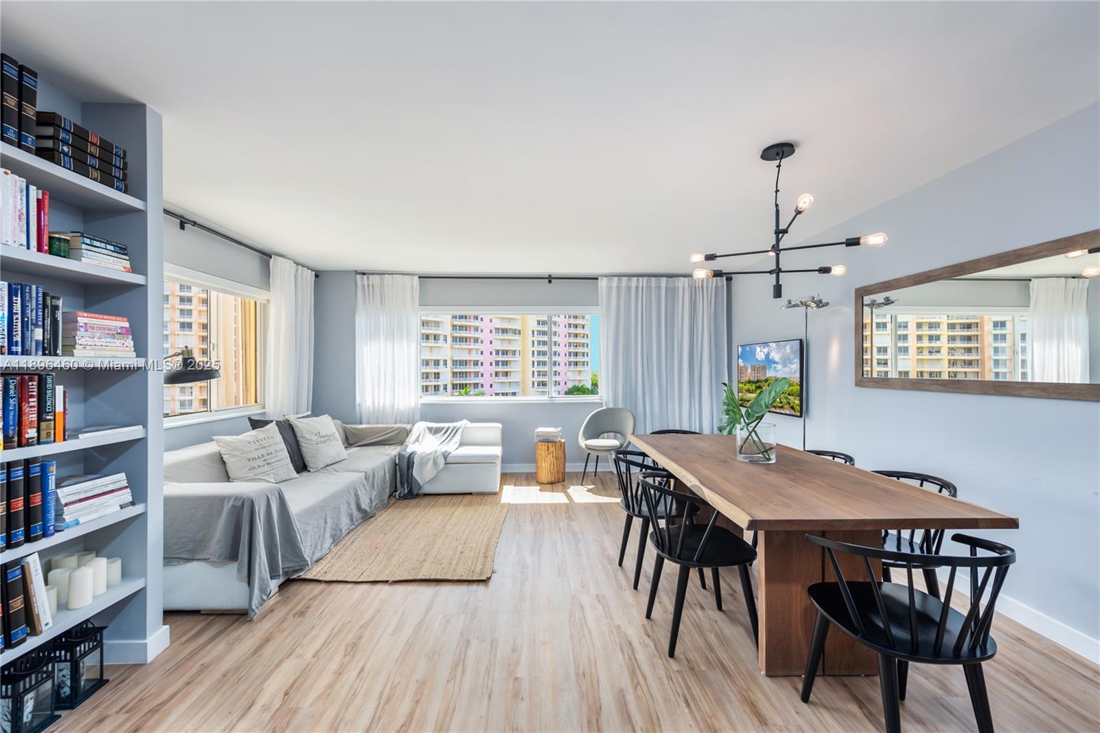 650 Ocean Drive, Unit 10E Key Biscayne, FL 33149 - Photo 4 of 20 a view of a dining room with furniture and a book shelf