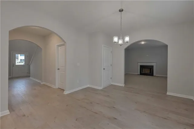 a view of a room with chandelier and entryway