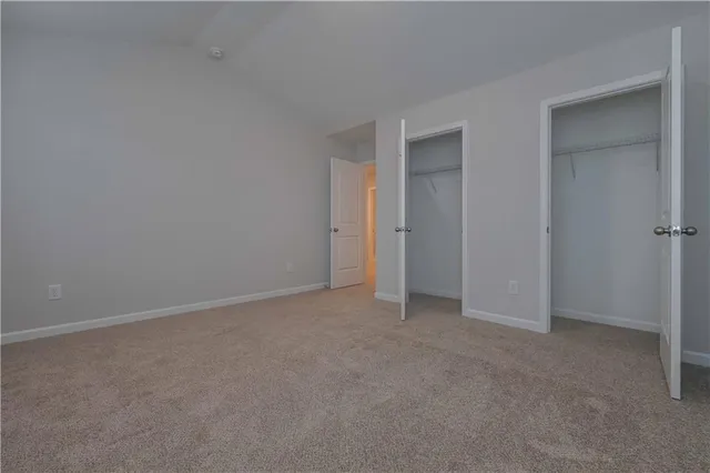 a view of an empty room and closet area