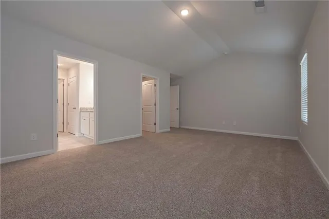 a spacious bathroom with a granite countertop sink a toilet and shower