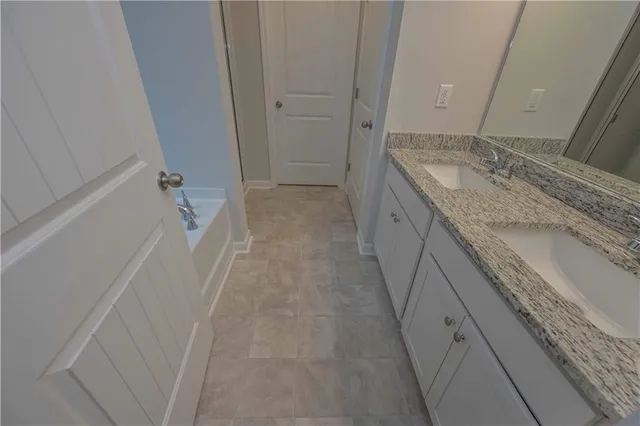 a bathroom with a granite countertop sink and vanity