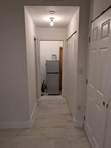 a kitchen with a refrigerator and cabinets
