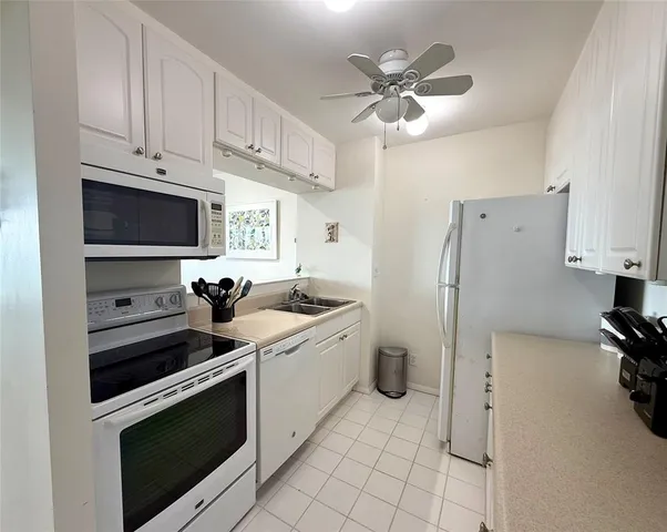 a kitchen with cabinets stainless steel appliances and a counter space