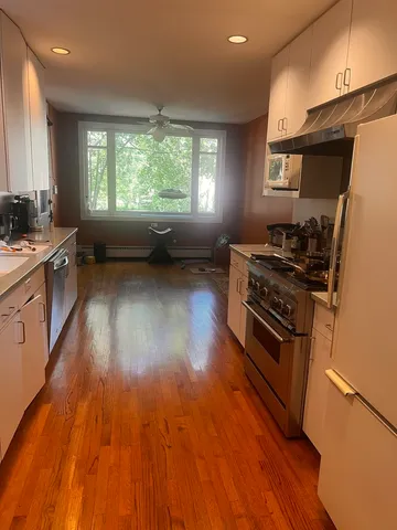 a kitchen with wooden floors and a stove