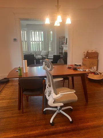 a view of a workspace with furniture and wooden floor