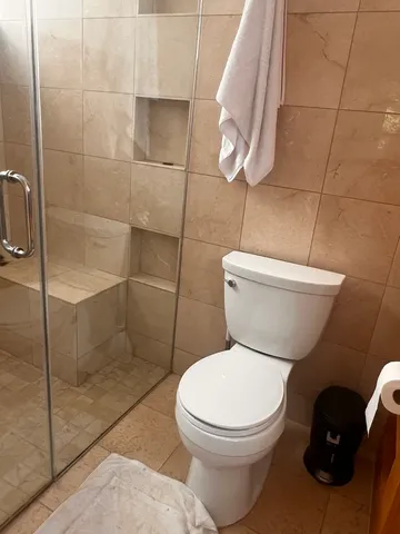 a white toilet sitting next to a bathroom sink