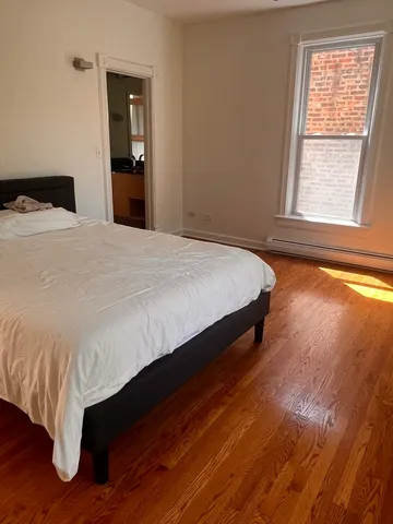 a bedroom with a bed and window