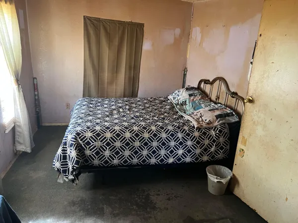a bedroom with a bed and a window