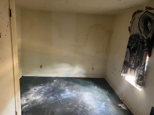 a bedroom with a bed and a mirror