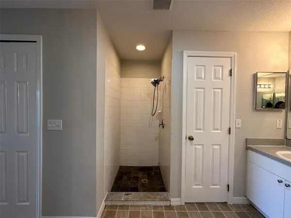 a bathroom with a sink and a shower