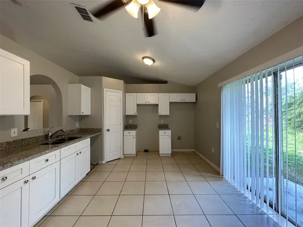 a kitchen with granite countertop a sink and cabinets