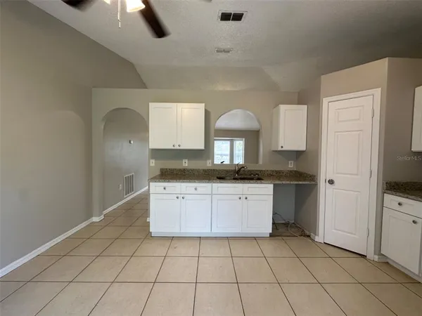 a kitchen with a sink a stove and cabinets