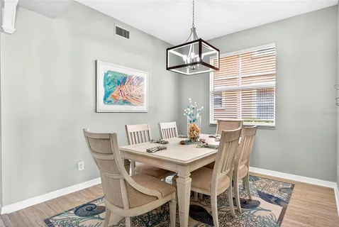 a view of a dining room with a table and chairs