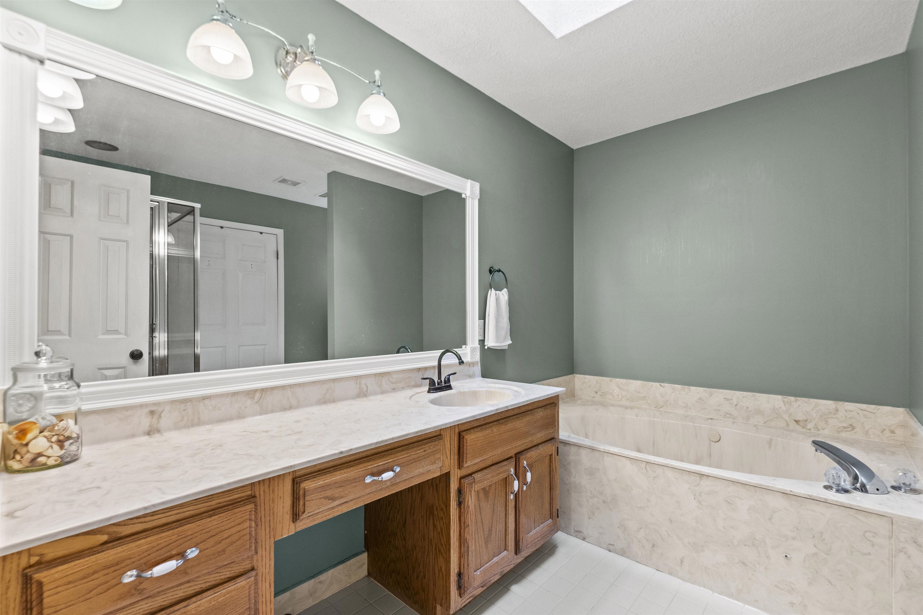 3601 Marshall Road Munford, TN 38058 - Photo 27 of 35 Bathroom featuring a wide vanity with natural wood-finish cabinetry, a single basin sink, and a large mirror