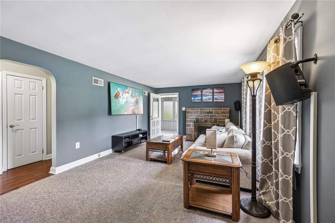 4065 Airport Road Allentown, PA 18109 - Photo 3 of 28 A welcoming living room featuring a stone-faced fireplace.
