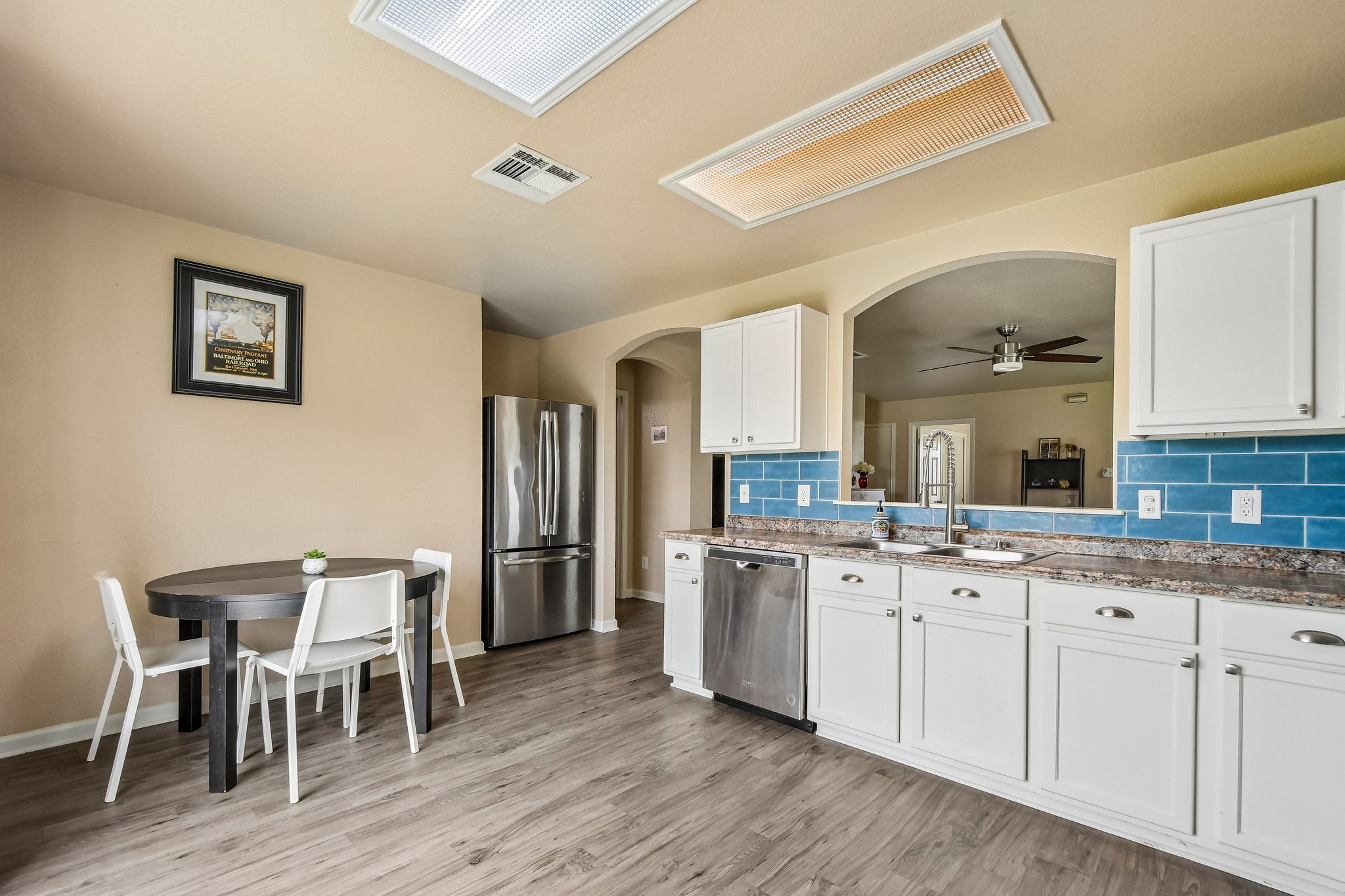 125 Mason Reed Cove Kyle, TX 78640 - Photo 12 of 39 a kitchen with a sink cabinets and wooden floor