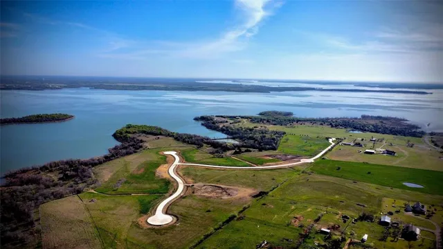 an aerial view of a house with garden space and street view
