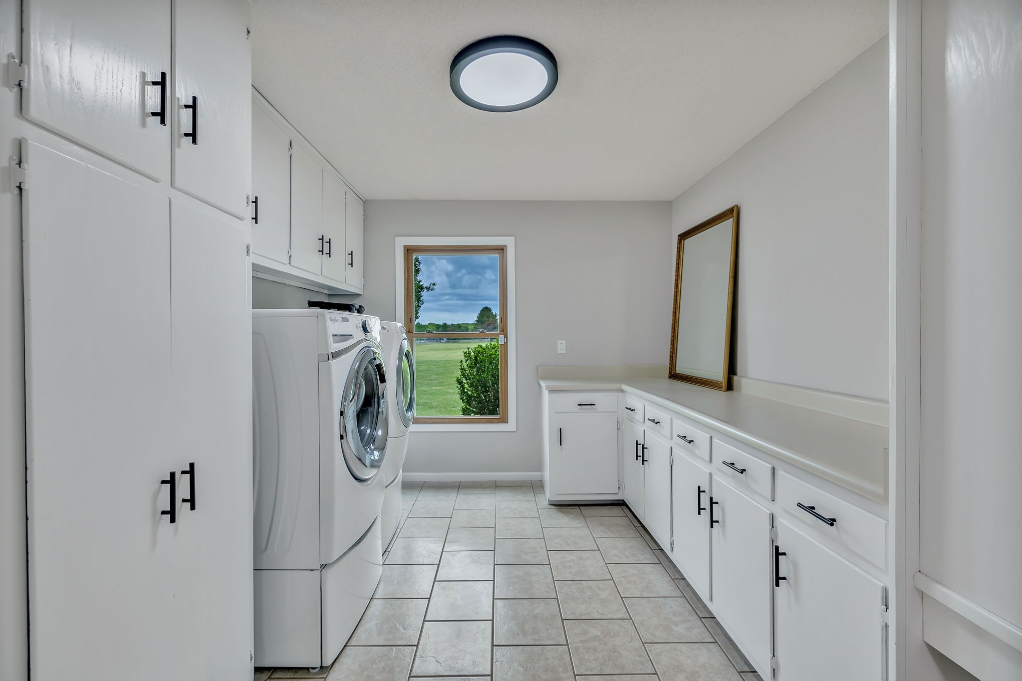 7068 Miller Road Christiana, TN 37037 - Photo 33 of 52 a hall with a refrigerator a washer dryer and cabinets