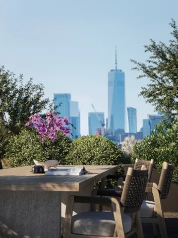a view of a patio with table and chairs and potted plants