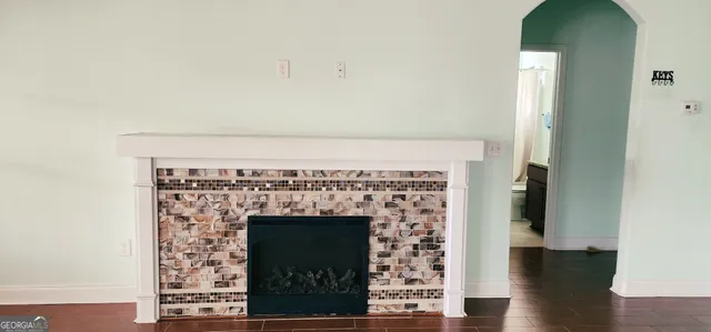 a bathroom with a granite countertop sink toilet and mirror