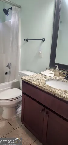 a view of hallway with wooden floor and stairs