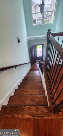 a living room filled with furniture and large windows