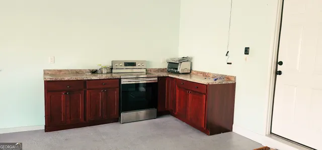 a kitchen with granite countertop a sink and cabinets