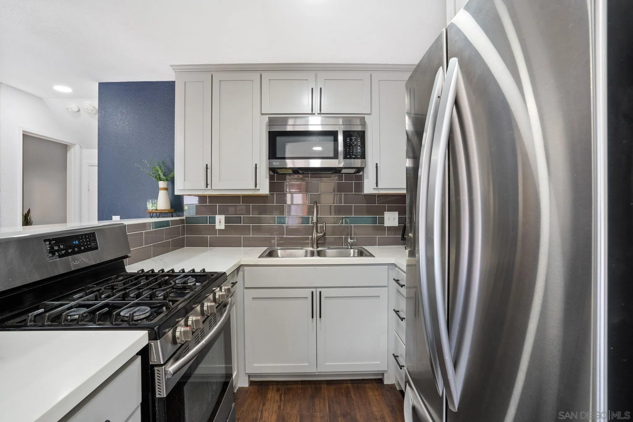 2012 Terracina Circle Spring Valley, CA 91977 - Photo 9 of 34 a kitchen with stainless steel appliances a sink stove and refrigerator