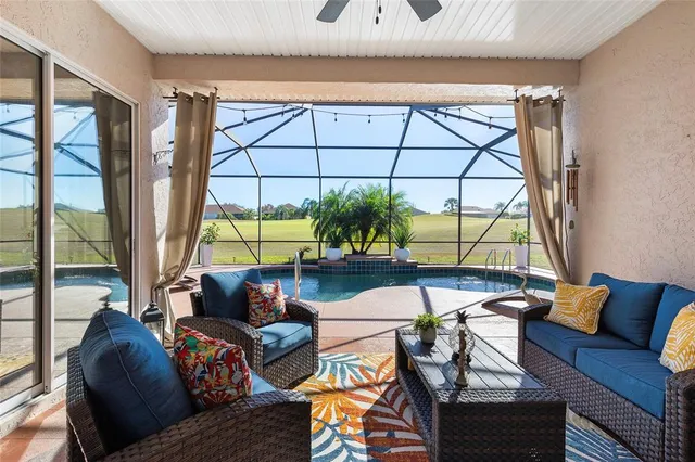 a living room with furniture and a floor to ceiling window