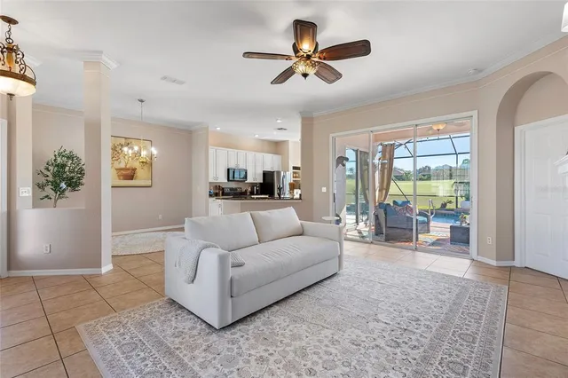 a living room with furniture and a large window with wooden floor