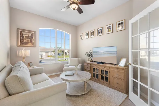 a living room with furniture a flat screen tv and a toilet