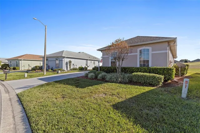 a view of a house with swimming pool and a yard