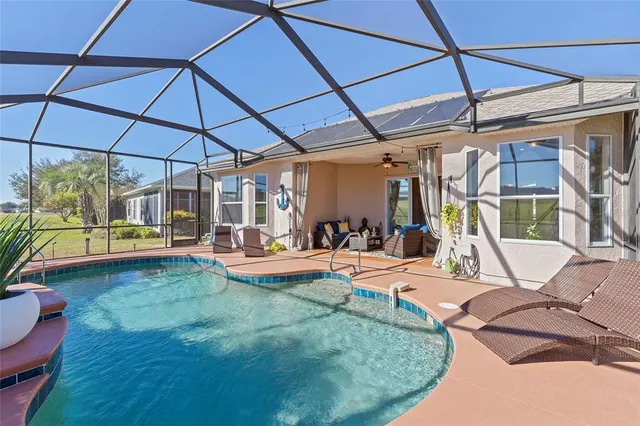 a view of a backyard with swimming pool