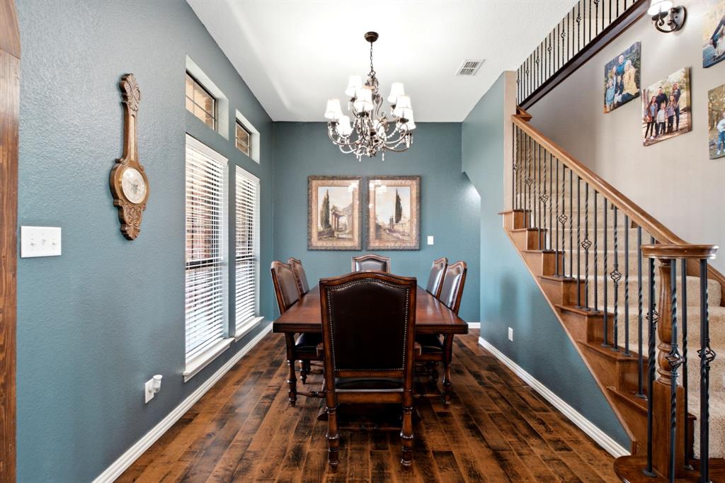 600 Aspen Street Pilot Point, TX 76258 - Photo 4 of 39 Formal dining space featuring wood-finish flooring and a decorative chandelier
