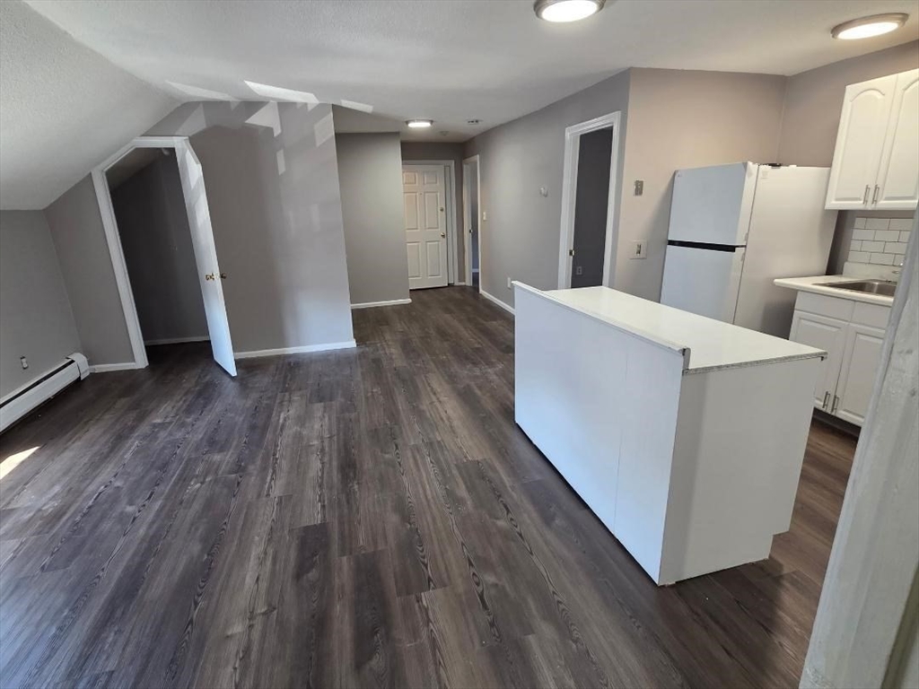 14 Carver Street, Unit 3 Fall River, MA 02721 - Photo 2 of 8 a view of a kitchen with wooden floor and electronic appliances