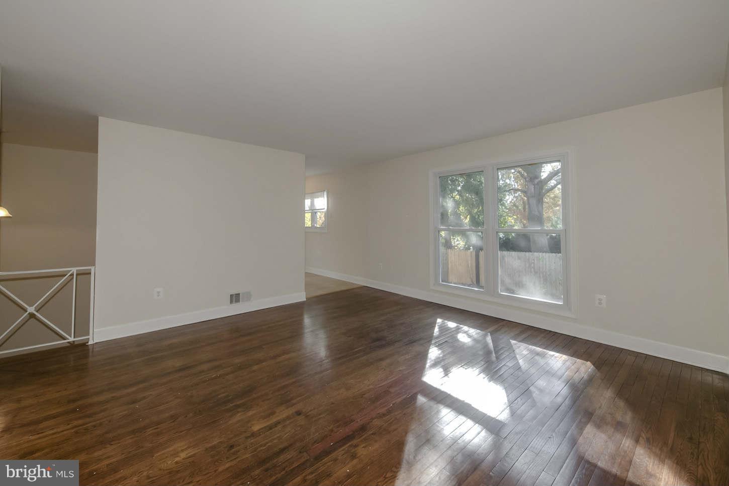 12906 Broadmore Road Silver Spring, MD 20904 - Photo 12 of 27 an empty room with wooden floor and windows
