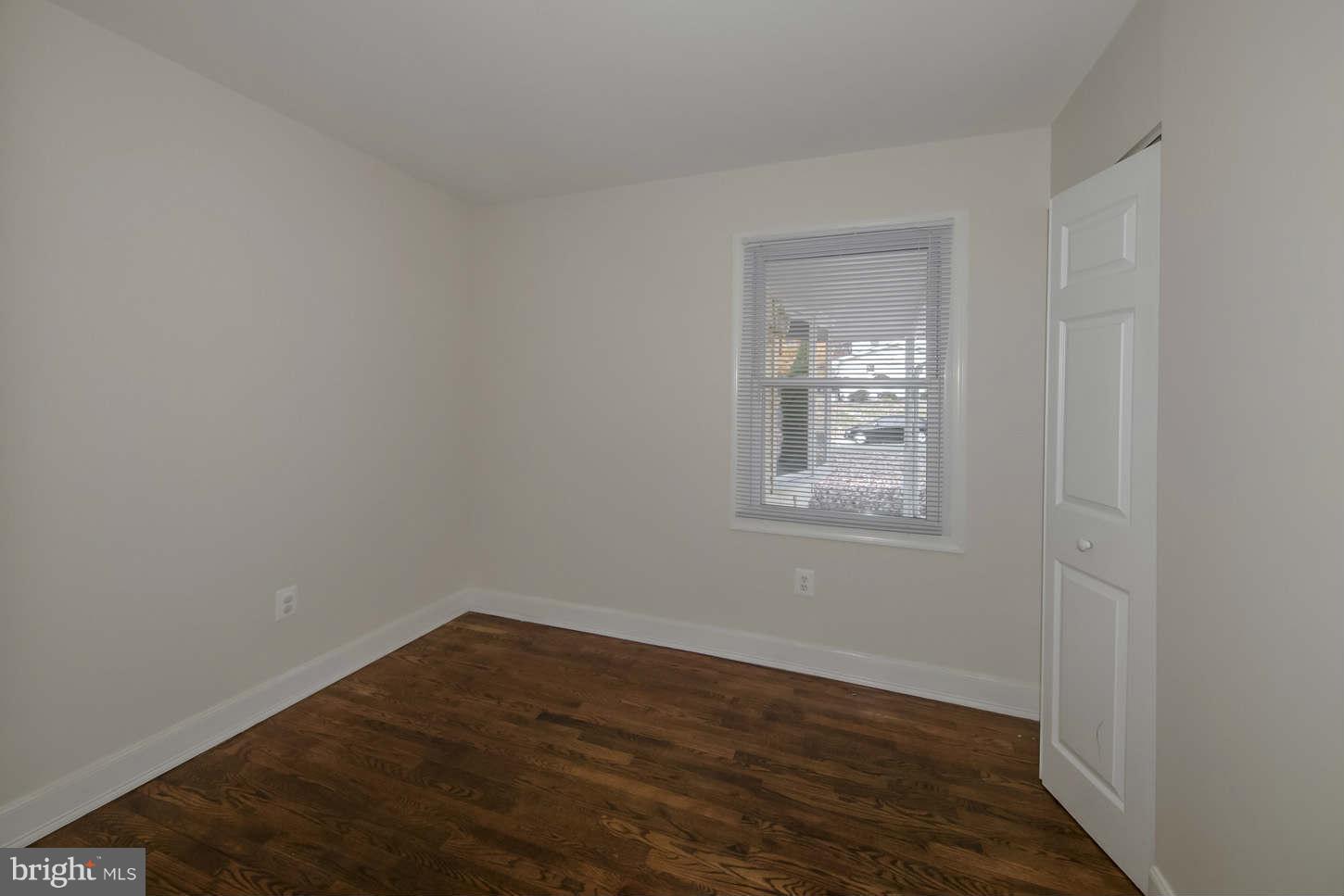 12906 Broadmore Road Silver Spring, MD 20904 - Photo 15 of 27 a view of an empty room with wooden floor and a window