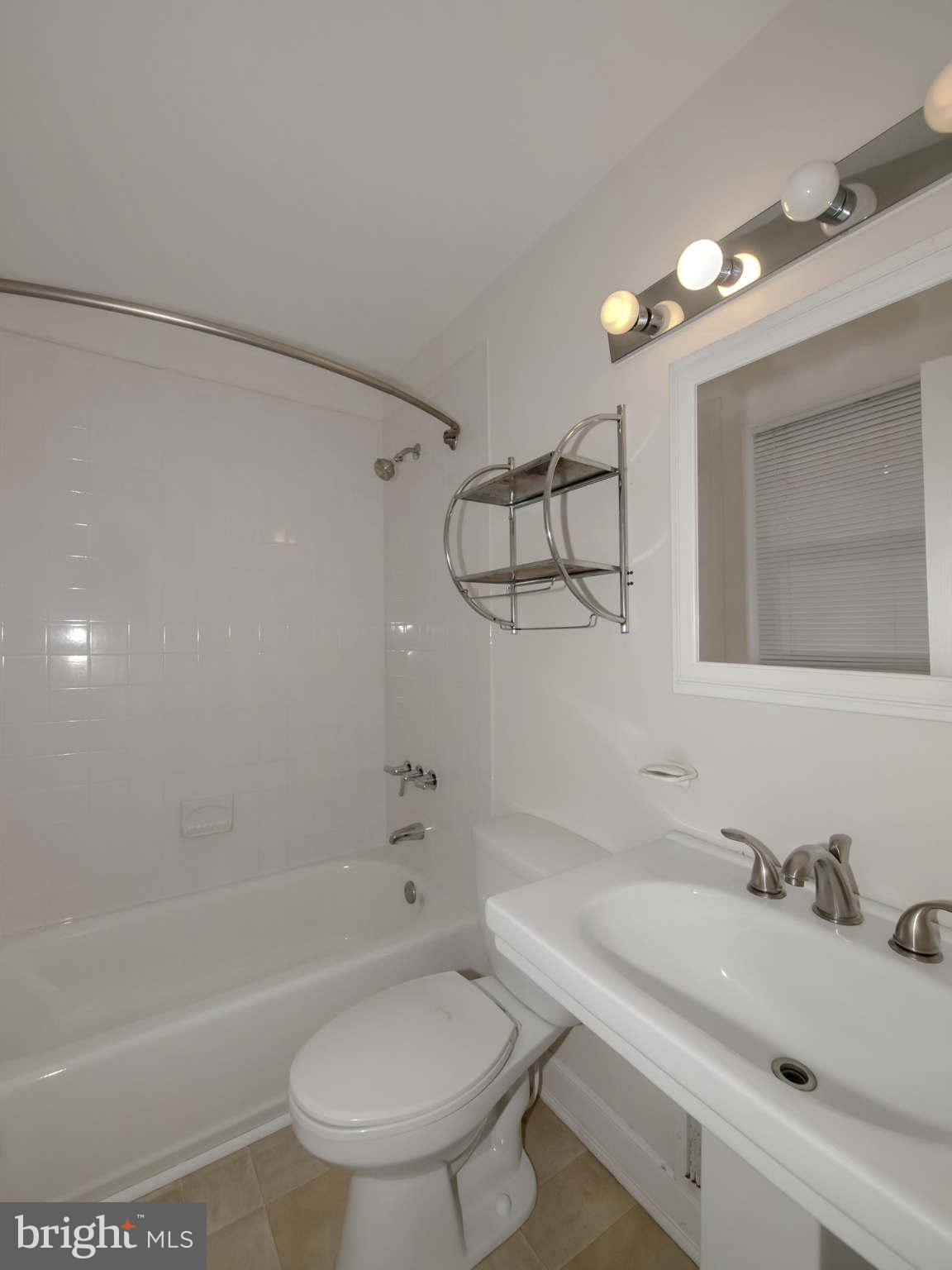 12906 Broadmore Road Silver Spring, MD 20904 - Photo 18 of 27 a bathroom with a sink toilet vanity and shower