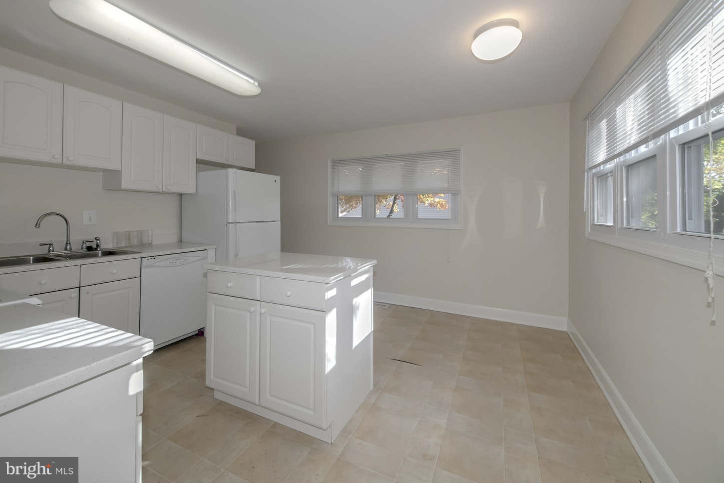 12906 Broadmore Road Silver Spring, MD 20904 - Photo 20 of 27 a kitchen with cabinets and washer dryer