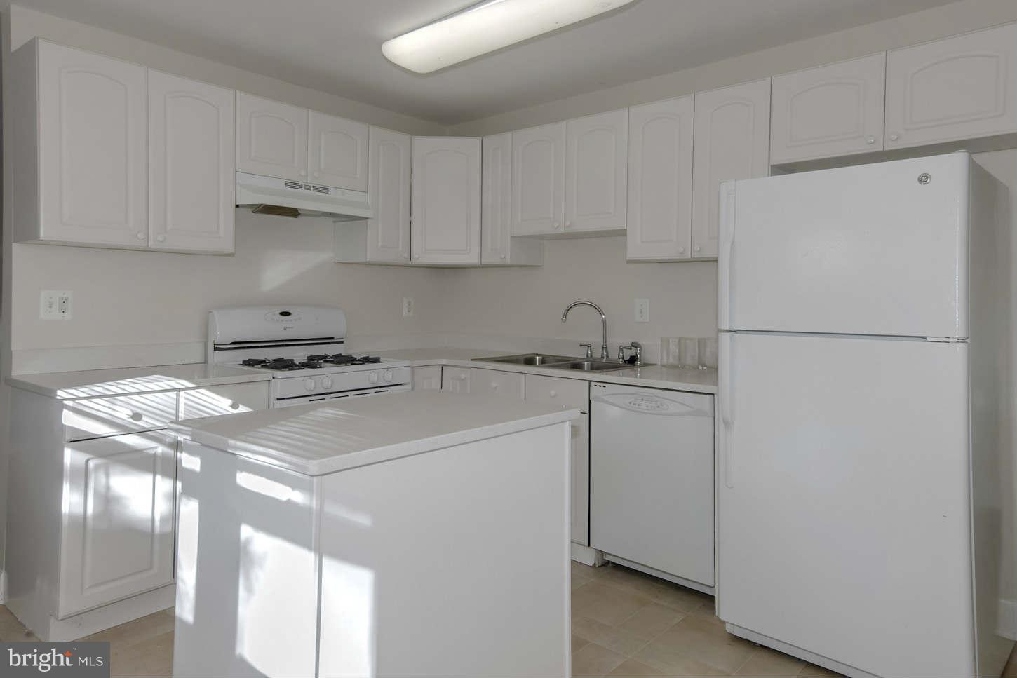 12906 Broadmore Road Silver Spring, MD 20904 - Photo 21 of 27 a white refrigerator freezer sitting in a kitchen