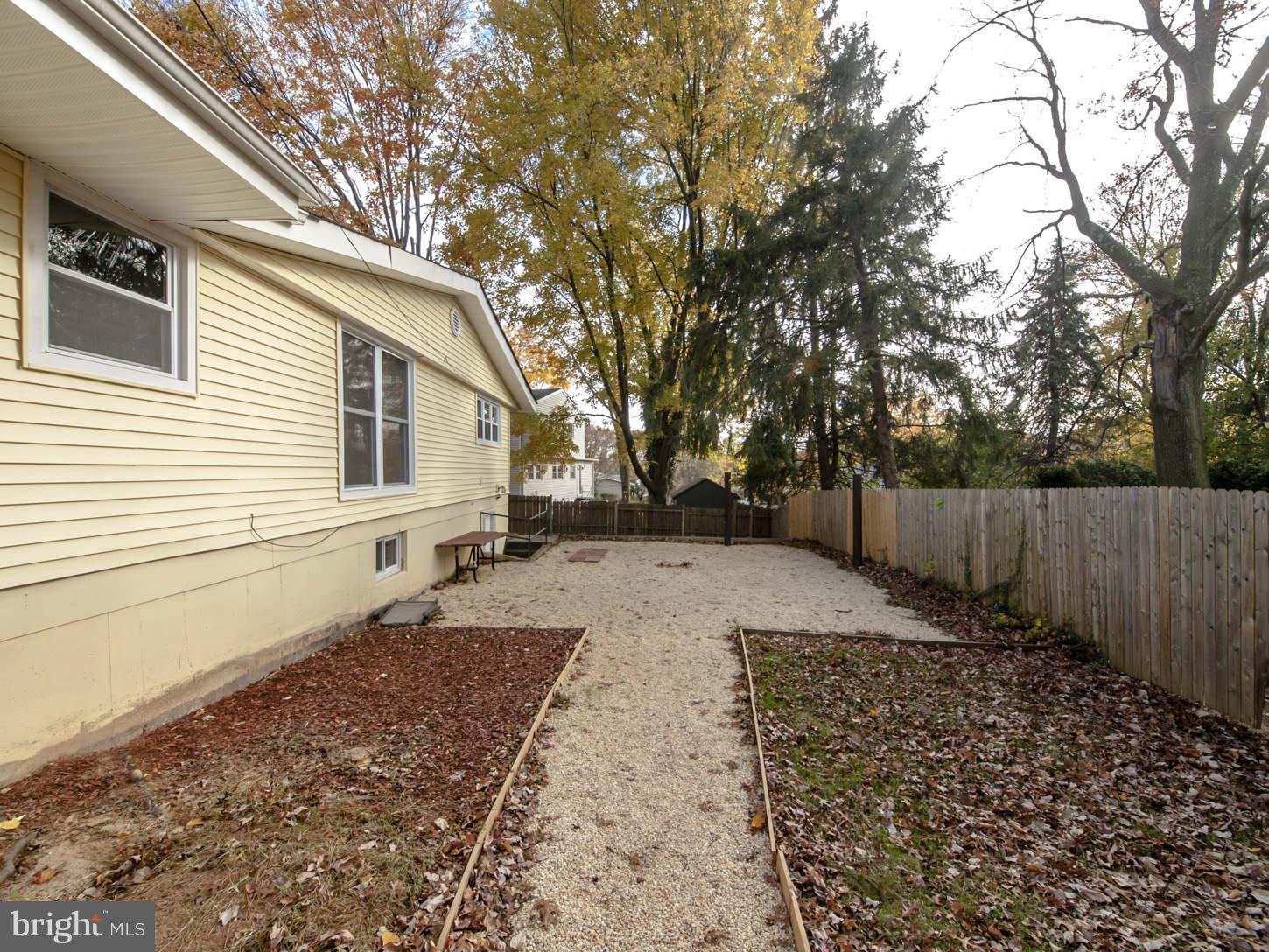 12906 Broadmore Road Silver Spring, MD 20904 - Photo 6 of 27 a view of a backyard with wooden fence and large trees