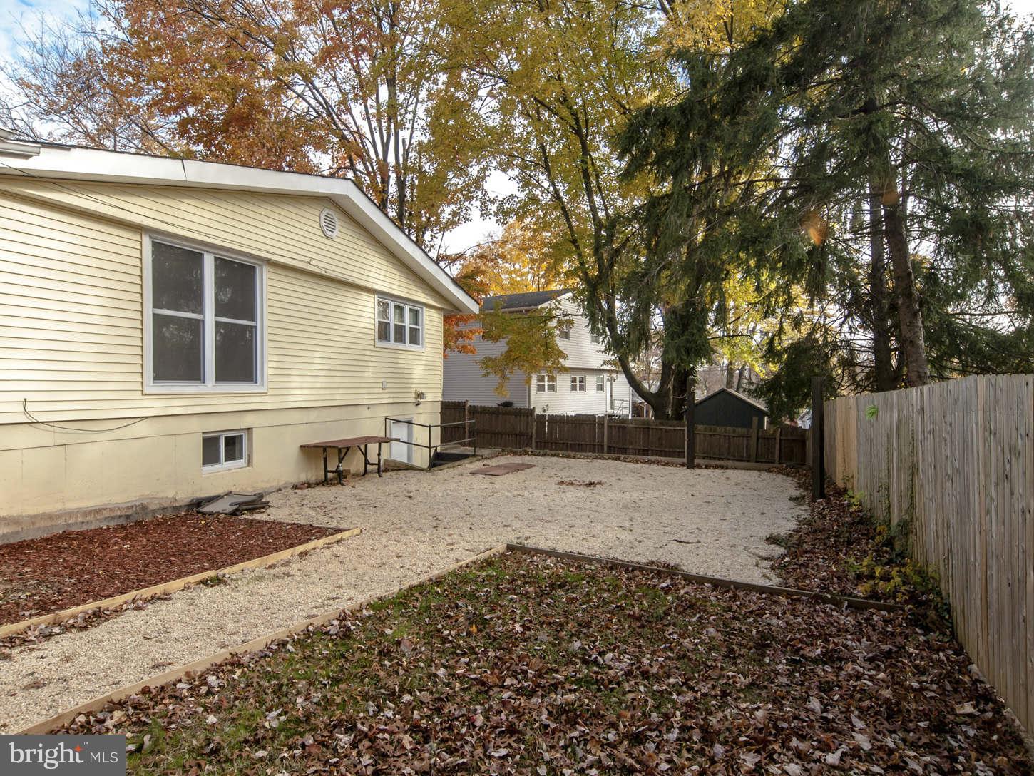 12906 Broadmore Road Silver Spring, MD 20904 - Photo 7 of 27 a backyard of a house with wooden fence