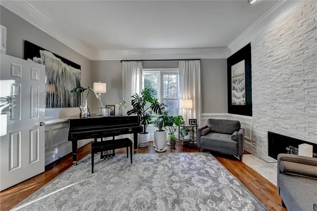 a kitchen with stainless steel appliances kitchen island granite countertop a table chairs and a refrigerator