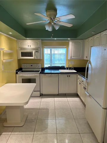 a kitchen with a stove a sink and a refrigerator