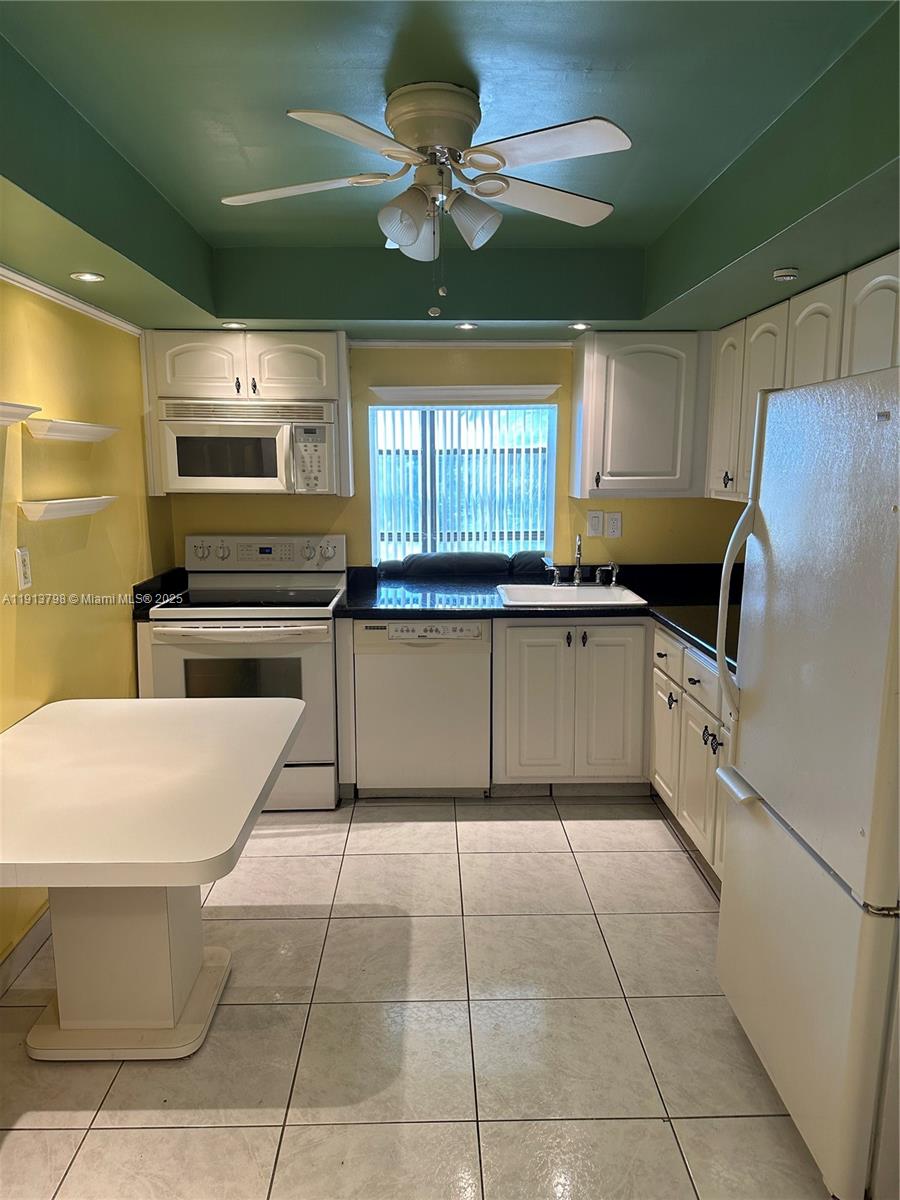 1000 Parkview Drive, Unit 325 Hallandale Beach, FL 33009 - Photo 2 of 7 a kitchen with a stove a sink and a refrigerator
